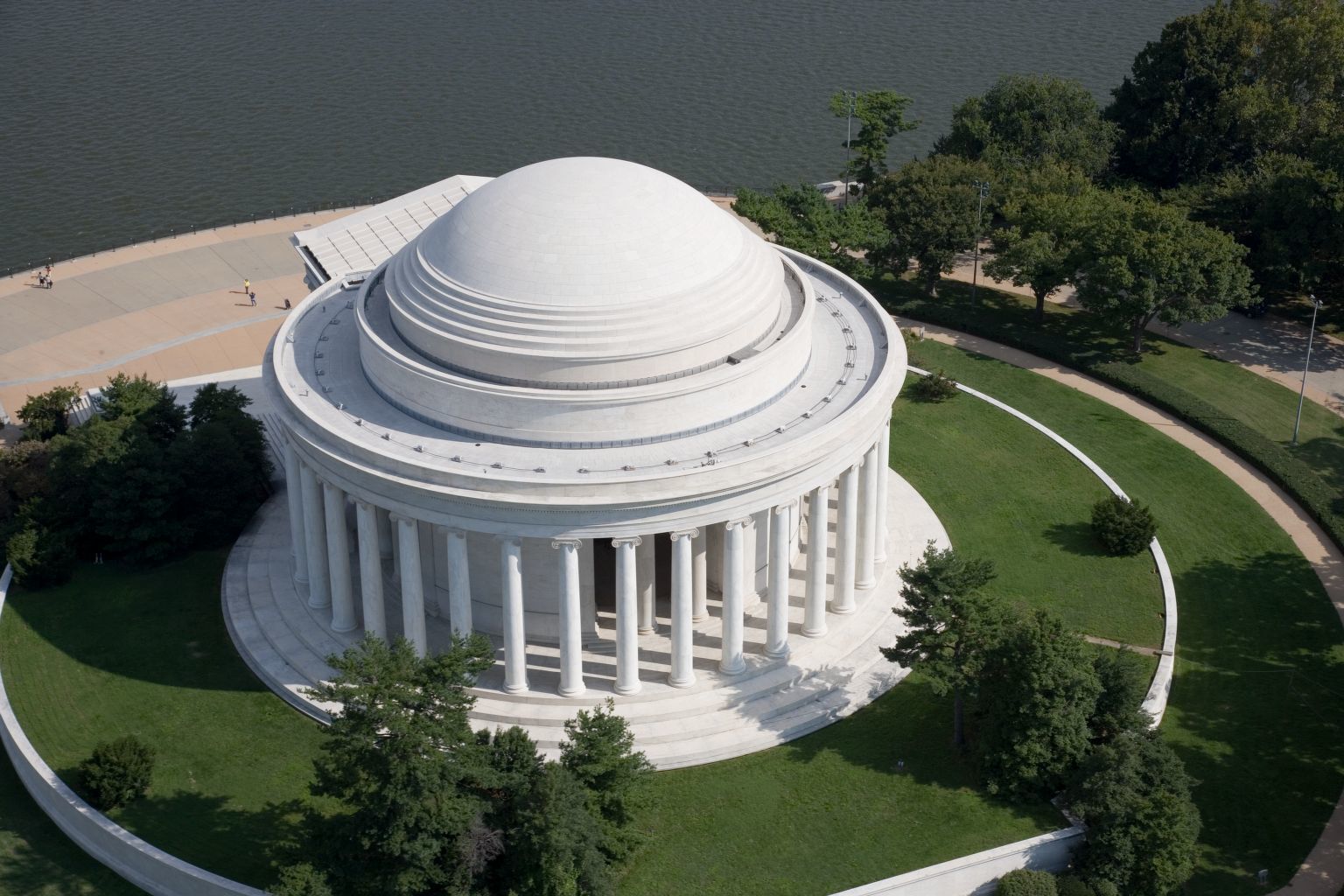 Large white circular building with columns around the outside