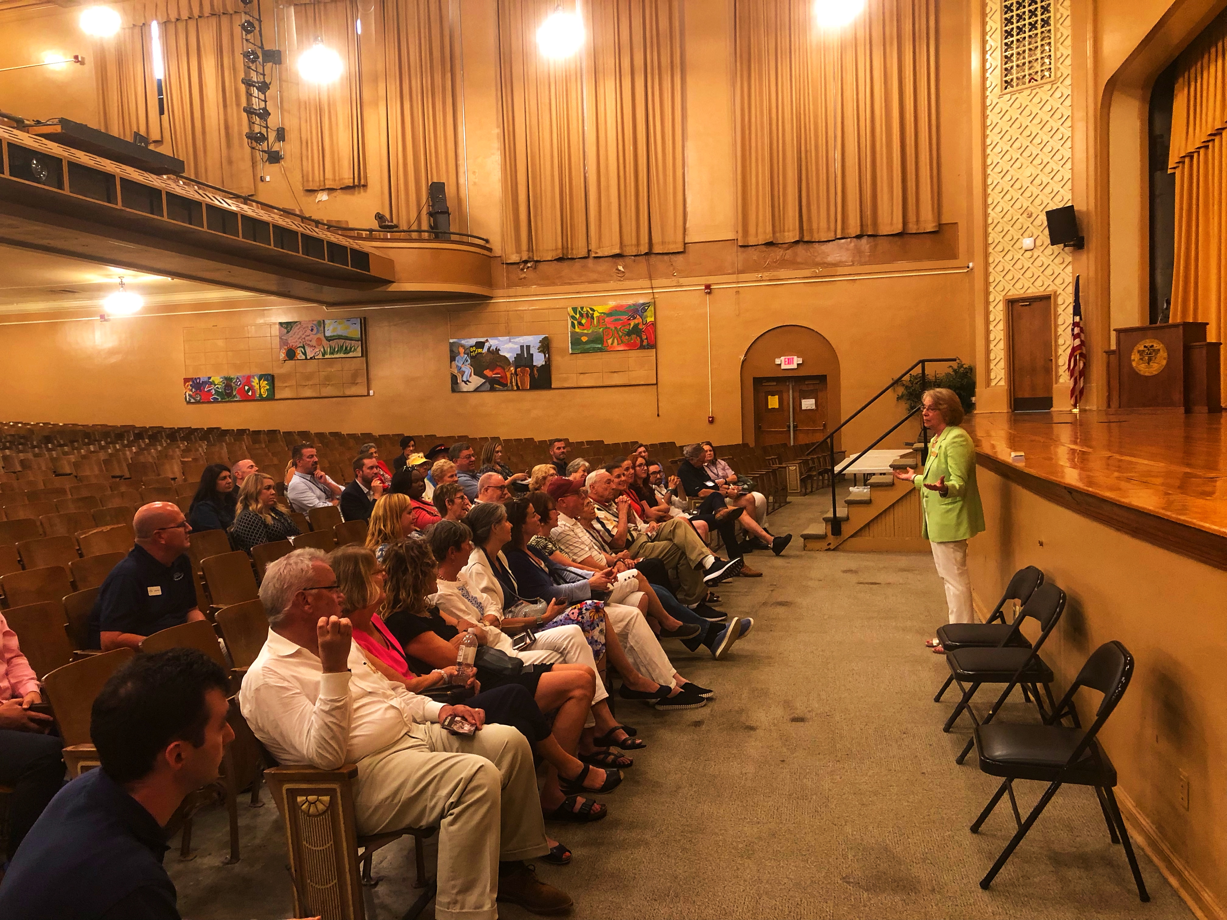 Tour participants sit inside Central High's auditorium on a ranger-led interpretive tour