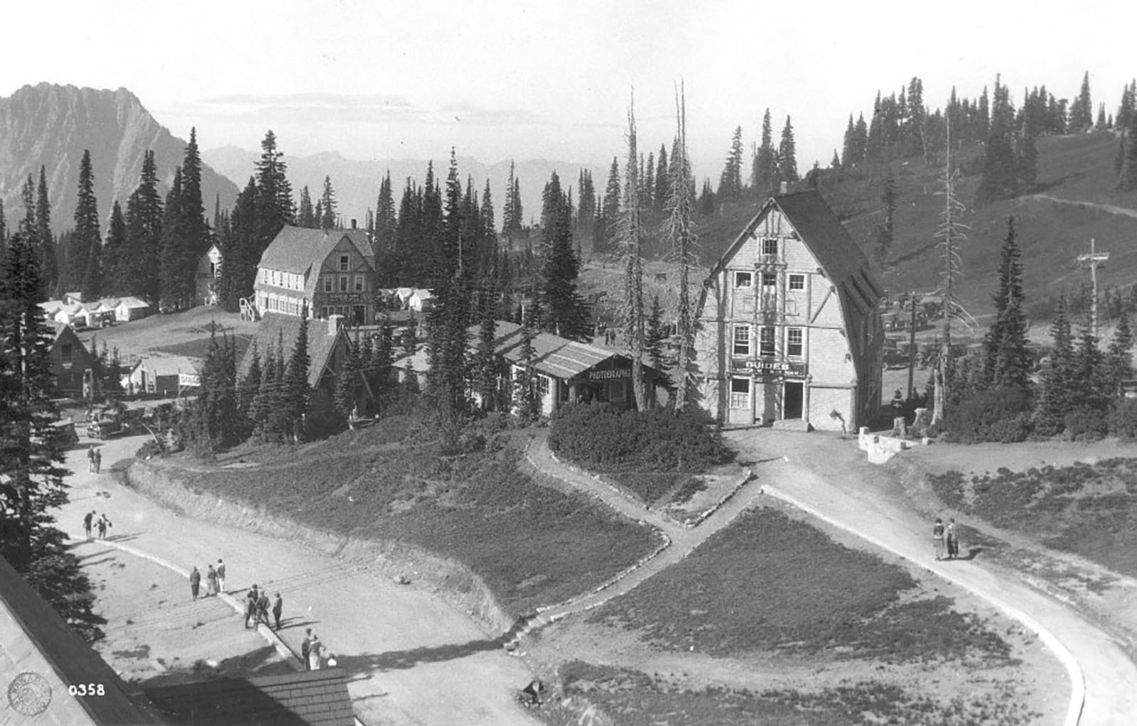 Buildings from the early 1900s with steeply pitched roofs surrounded by trees