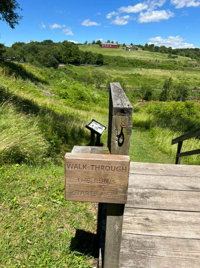 A wooden sign with steps that goes into the former lakebed.