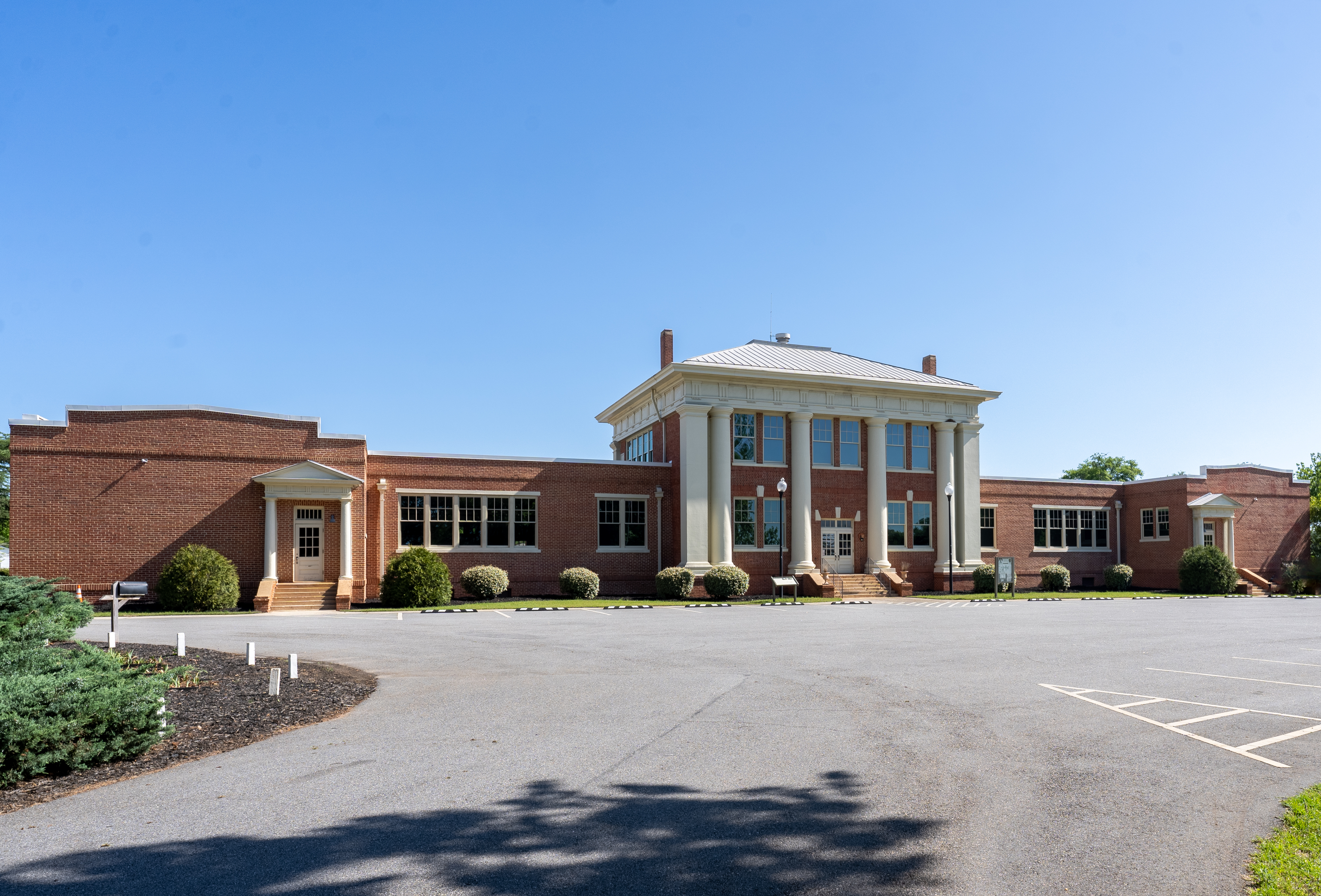 A red brick building with white columns.