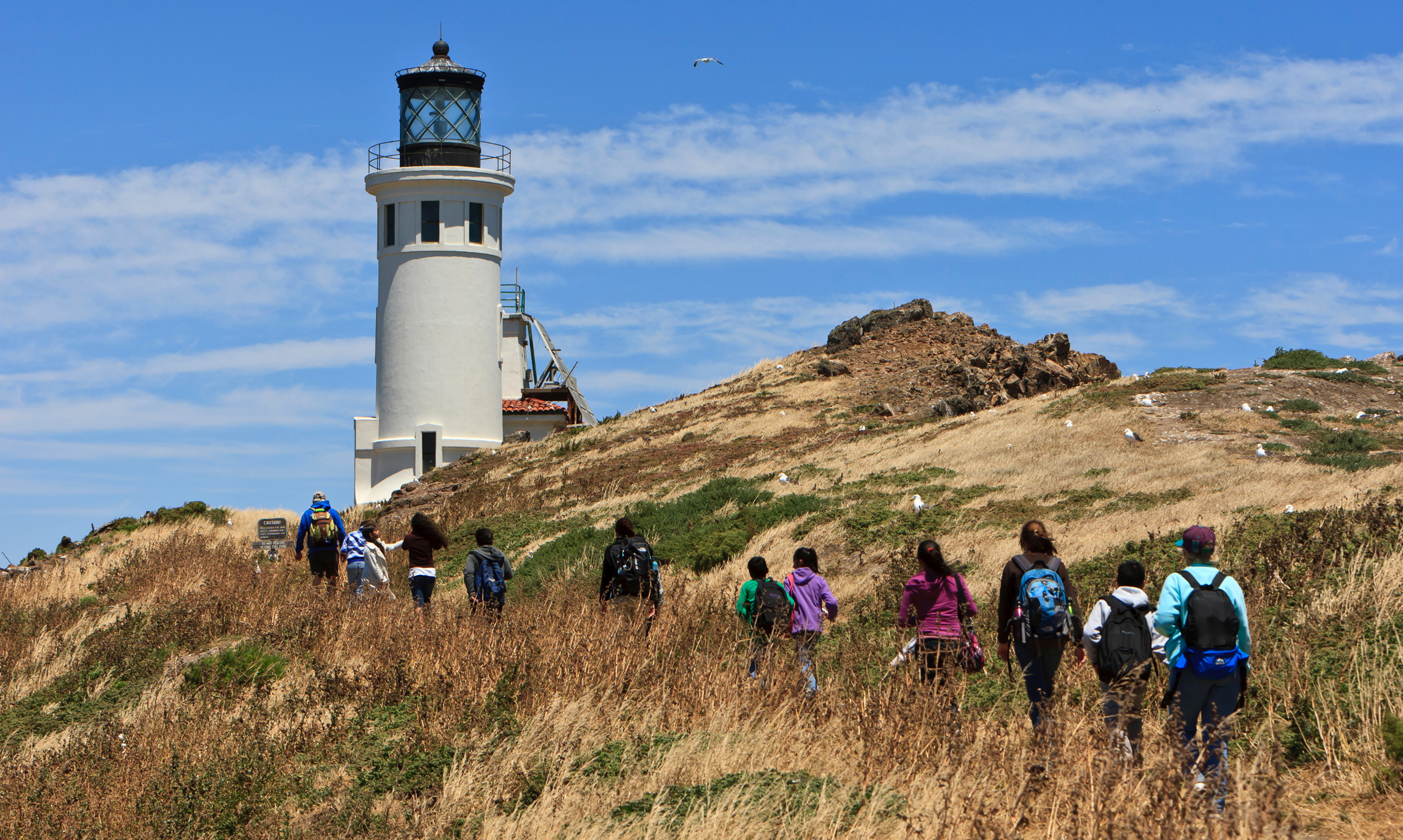 visitors walking towards lighthouse