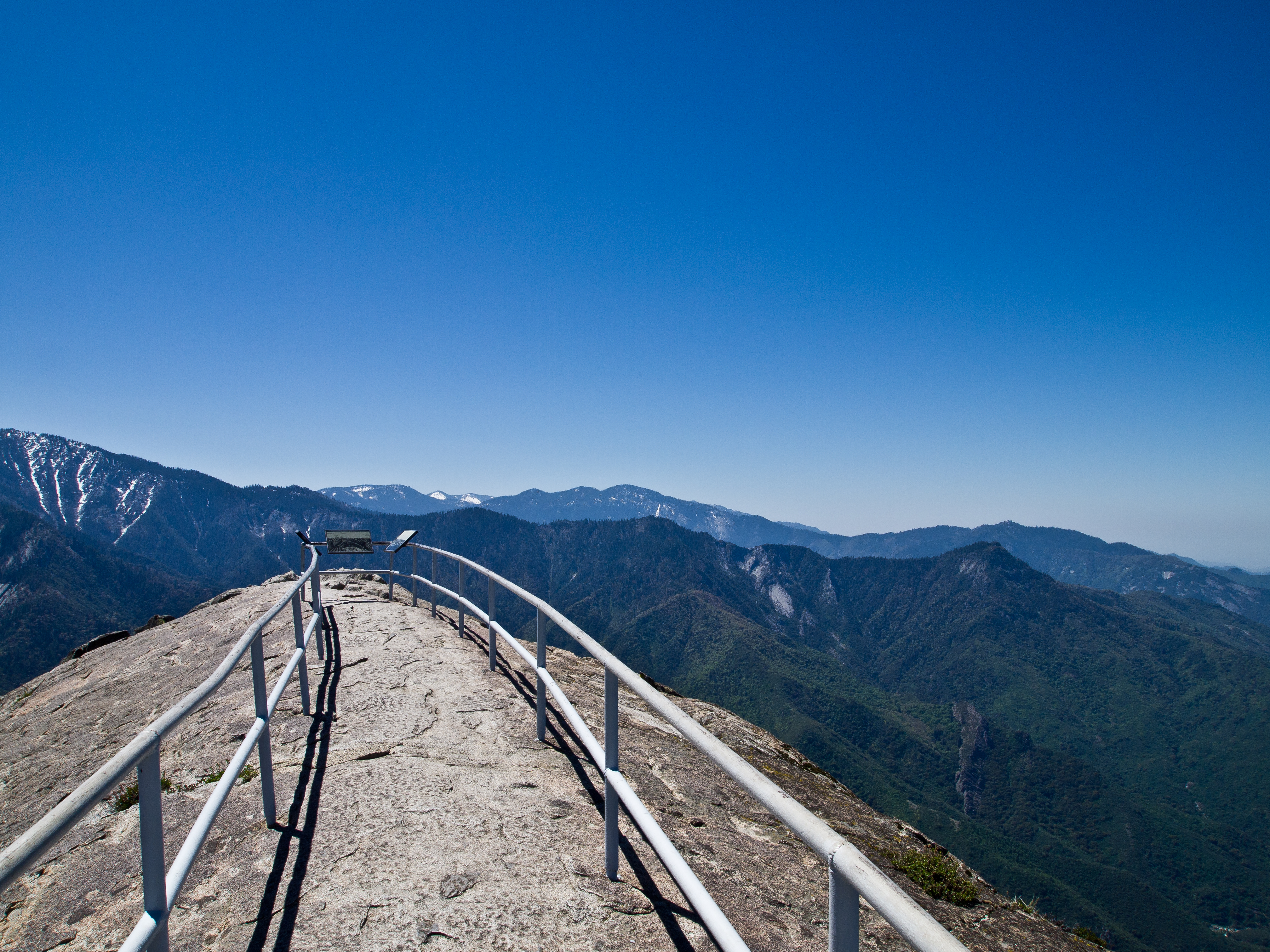 A narrow viewing area with metal railings