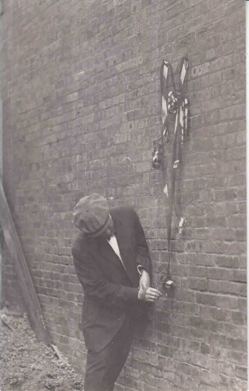 A man prepares to light a spool of celluloid film on fire.