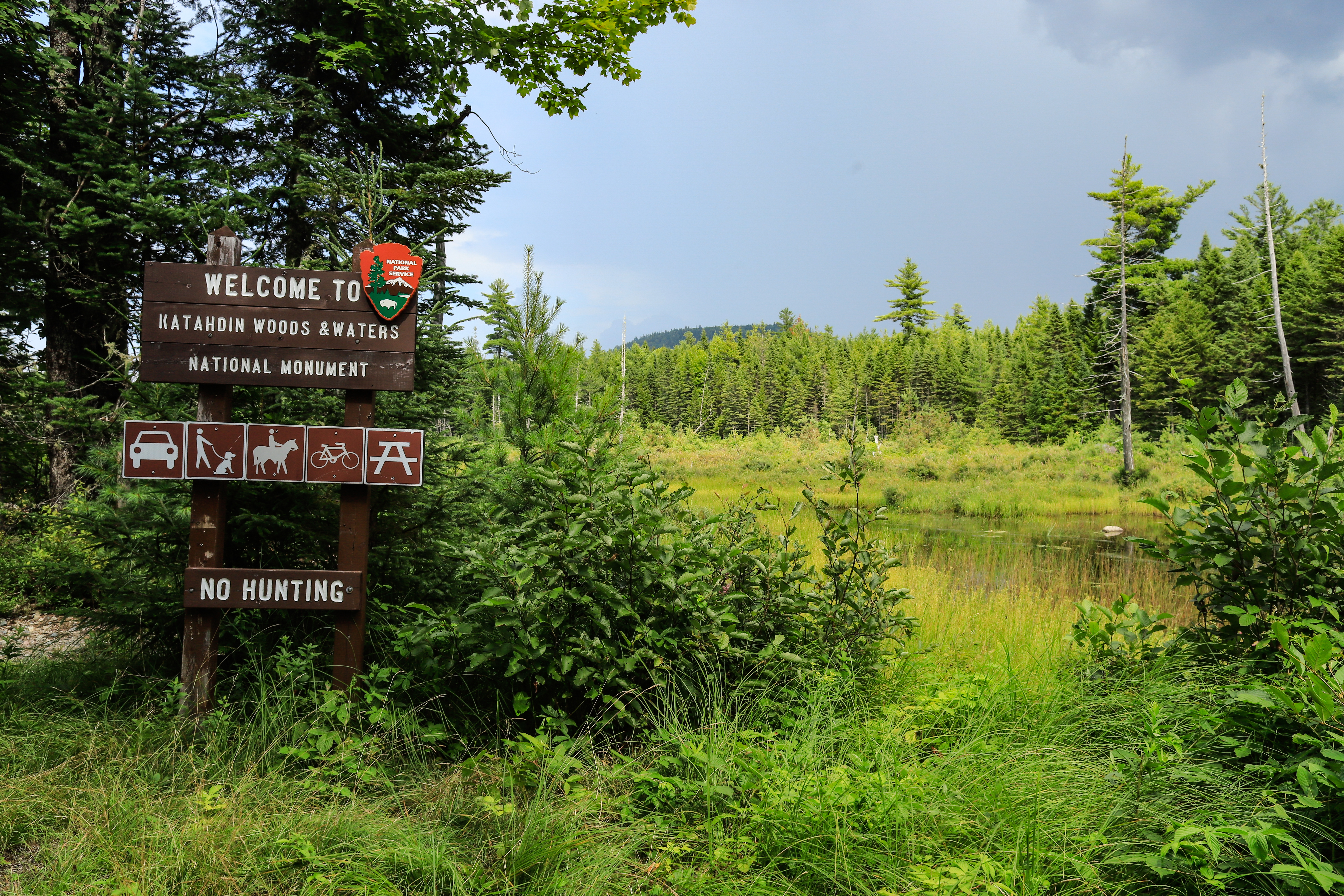 A picture of the NPS welcome sign at the start of the loop road on a sunny and overcast day.