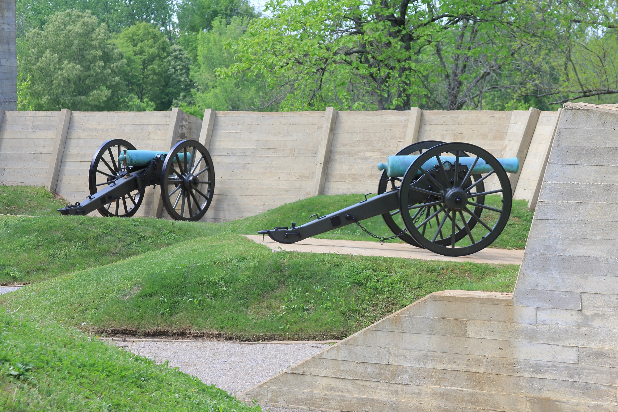 Two field cannon rest in replica embrasures on display.