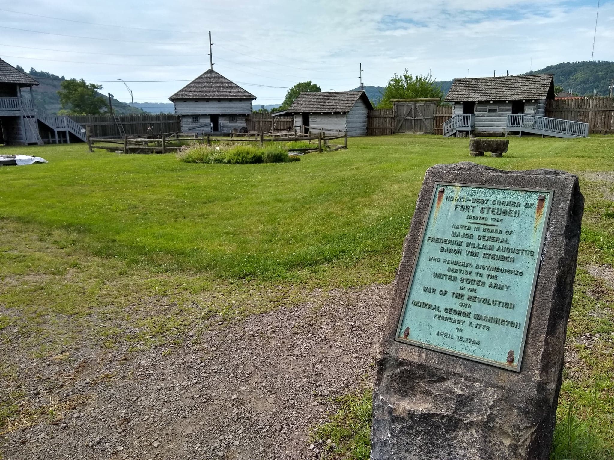 Interpretive sign near wooden fort