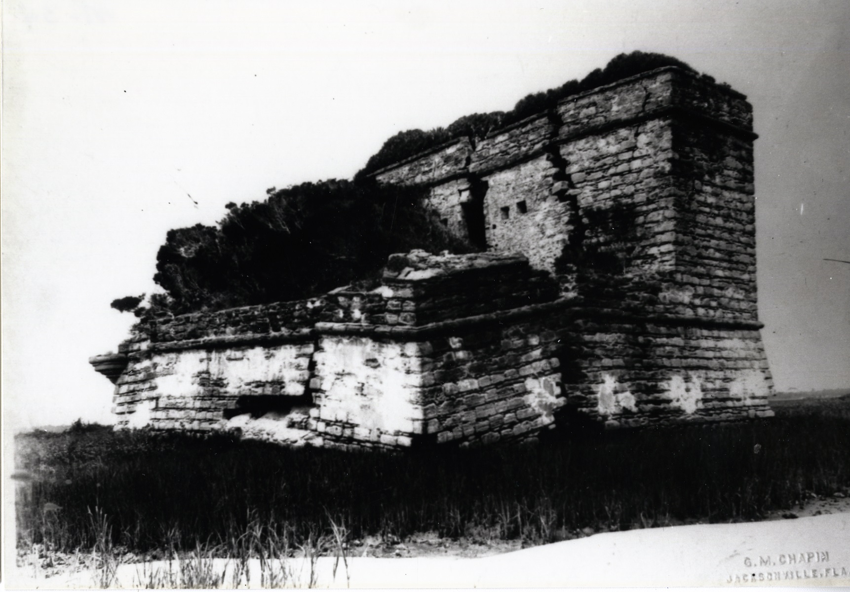 Black and White Photo of Fort Matanzas with many cracks and trees