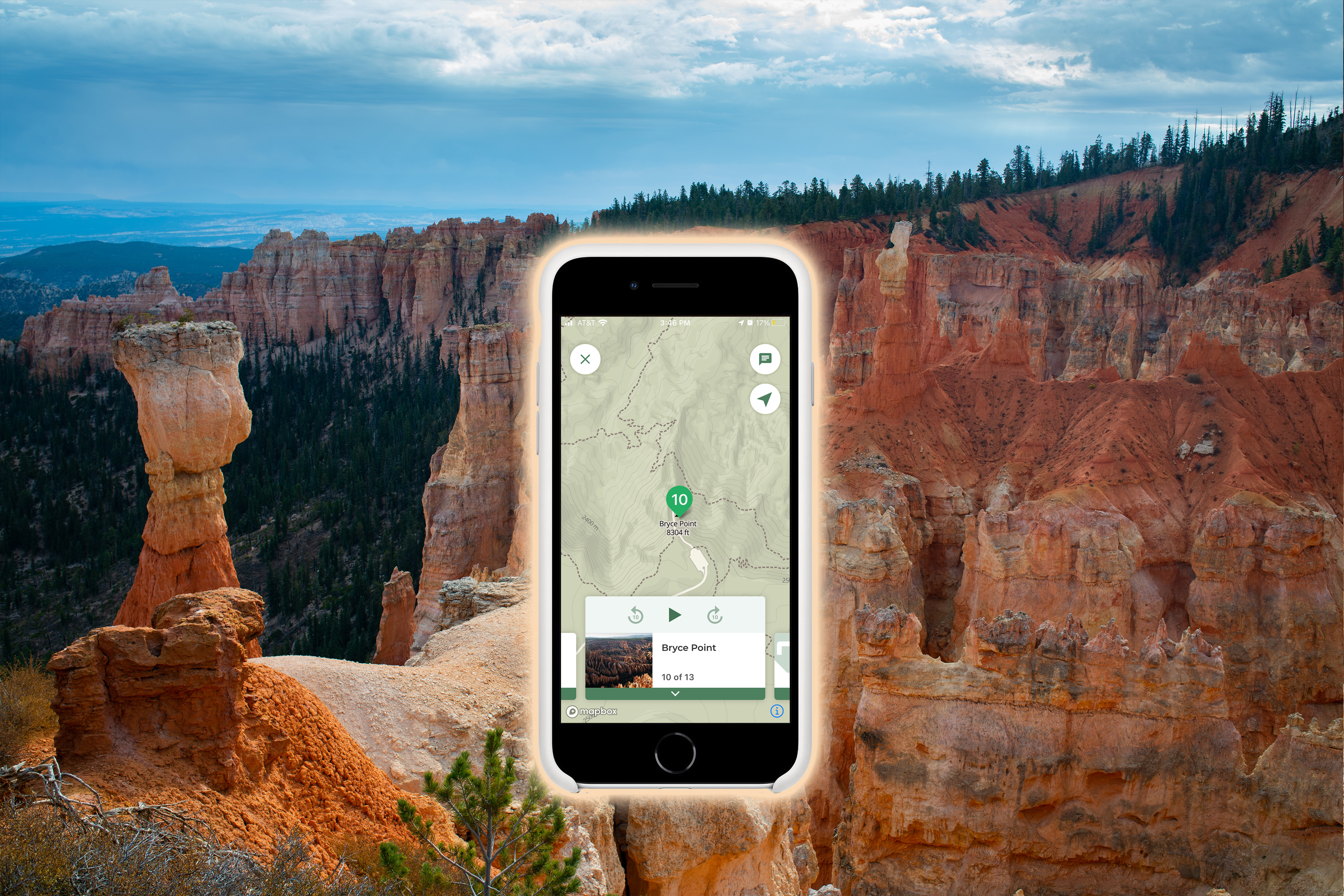 A smartphone with a map and details for Bryce Point superimposed on a forested landscape..