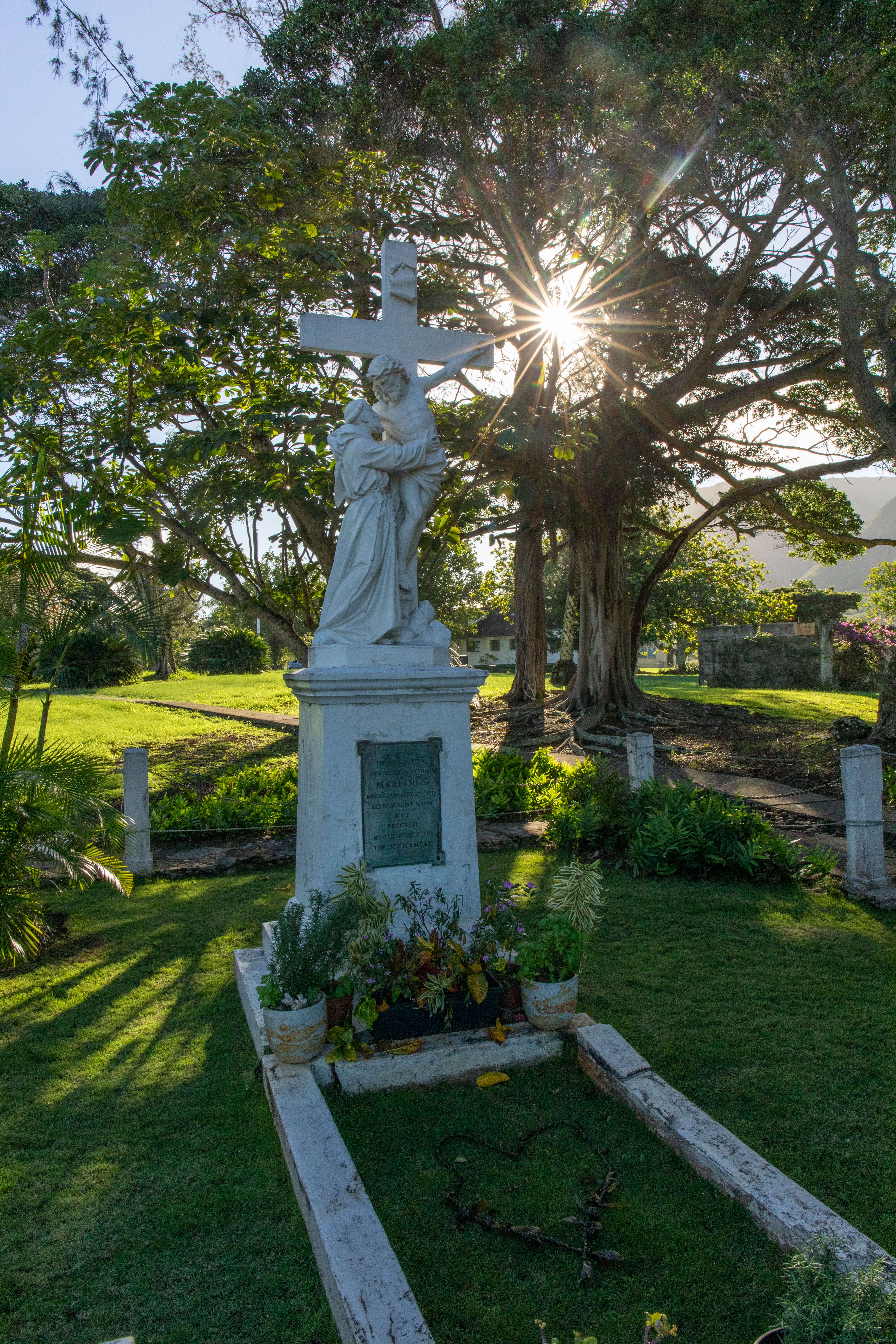 A statue with two men, one is on a cross.