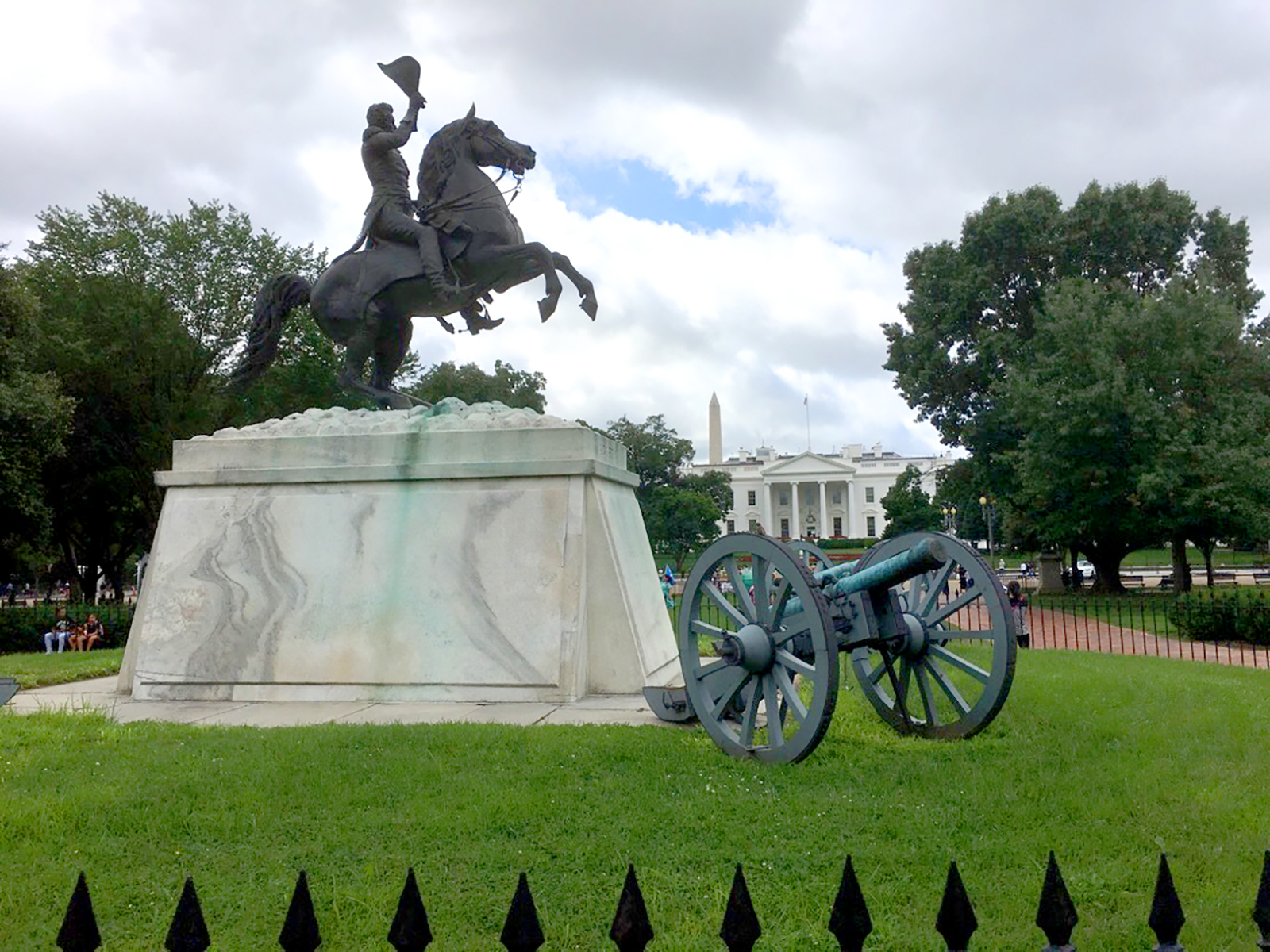 Bronze statue of Andrew Jackson on horseback with the White House in the background.