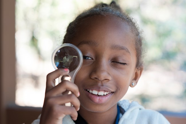 Child with Magnifying Glass
