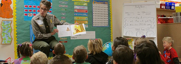 A ranger reads to a kindergarten class