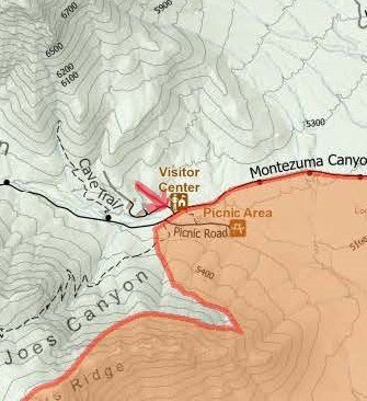 Topographic map with red arrow pointing at visitor center icon.