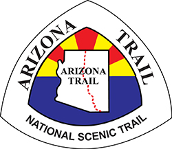 Arizona Trail logo - outline of state of AZ with trail intersection