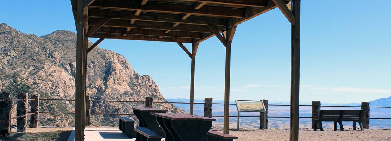A ramada structure with tables at a mountain overlook