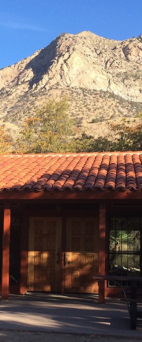 Visitor center building entrance and mountain peak in background