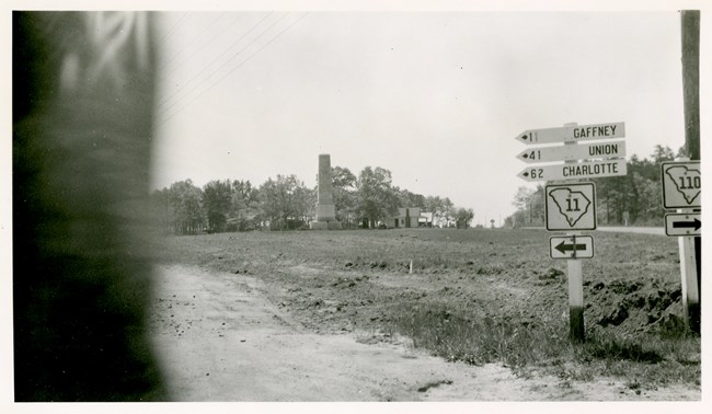 Black and white photo of US Monument and road signs