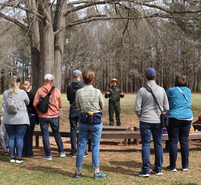 Park Ranger presents talk to a group of people.