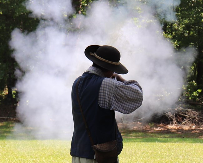 Living historian fires a musket