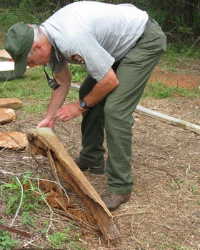 Park employee examining rotted chimney lintel