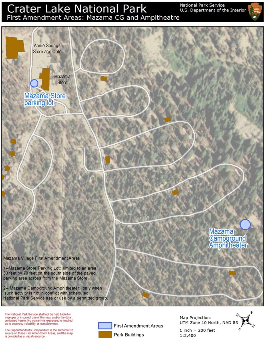 A map of Mazama Village, campground and parking area. Roads are white. Buildings are brown. Blue dots in Mazama Store Parking lot and at Mazama Campground Amphitheater mark First Amendment Areas. Related text in lower left corner.
