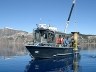 Research Vessel Neuston hoists a sediment trap in Crater Lake. Research Vessel Neuston hoists a sediment trap in Crater Lake.