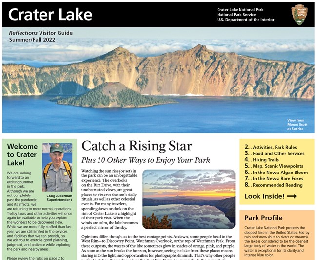 Image of the front fold of the summer 2022 Crater Lake newspaper a picture of the lake and wizard island above three columns of text. One that begins with welcome and has a photo of Craig Ackerman, Superintendent.