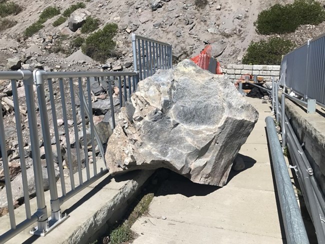 Image of large boulder that landed on the Cleetwood Marina pedestrian ramp and damaged the railing.