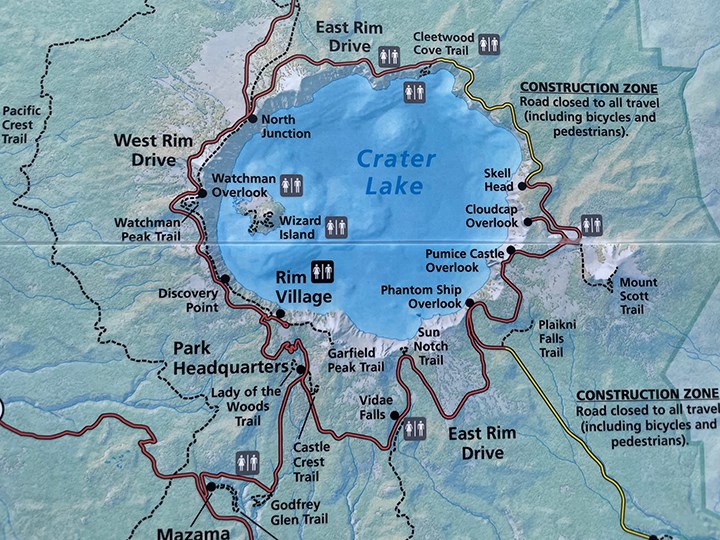 Topo map of Crater Lake National Park. The blue lake is in the center and surrounded by open roads in red and closed sections of roads in yellow.