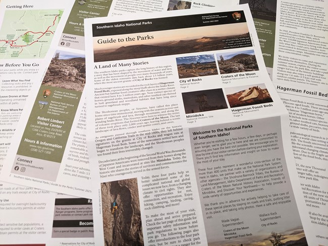 Printed copies of the park guide lay open on a table.