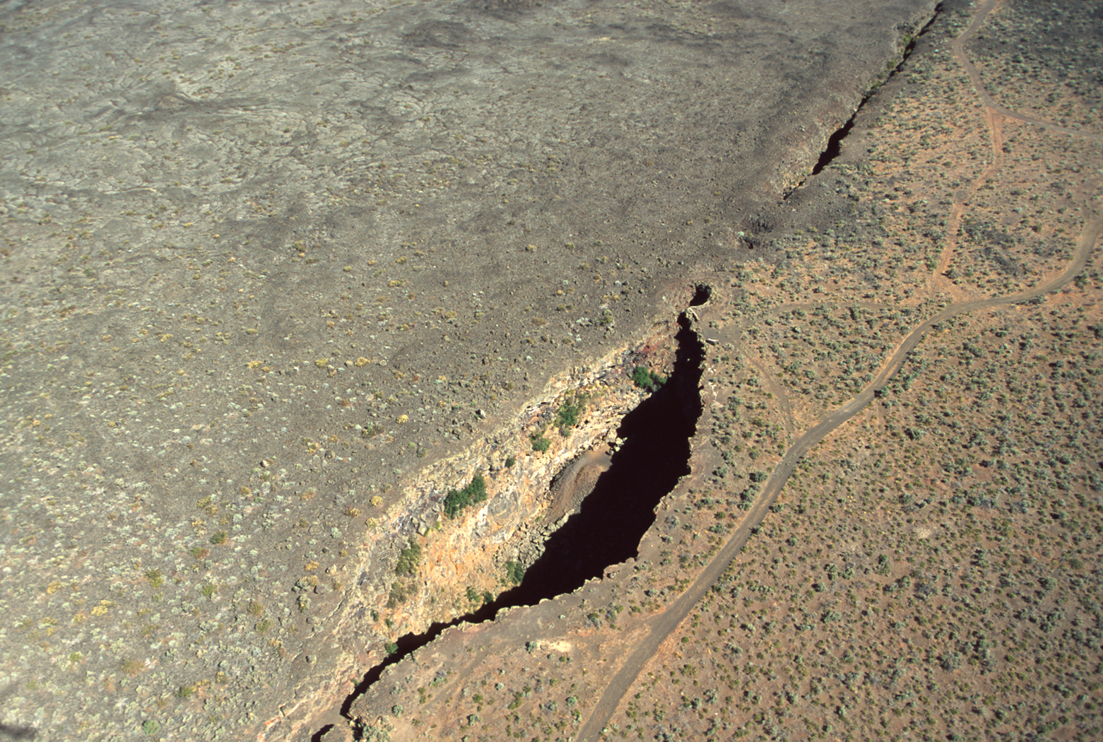 a deep fissure in the ground with a large open chasm in it