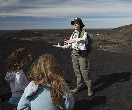 Intern talking to people in the foreground on cinder cone