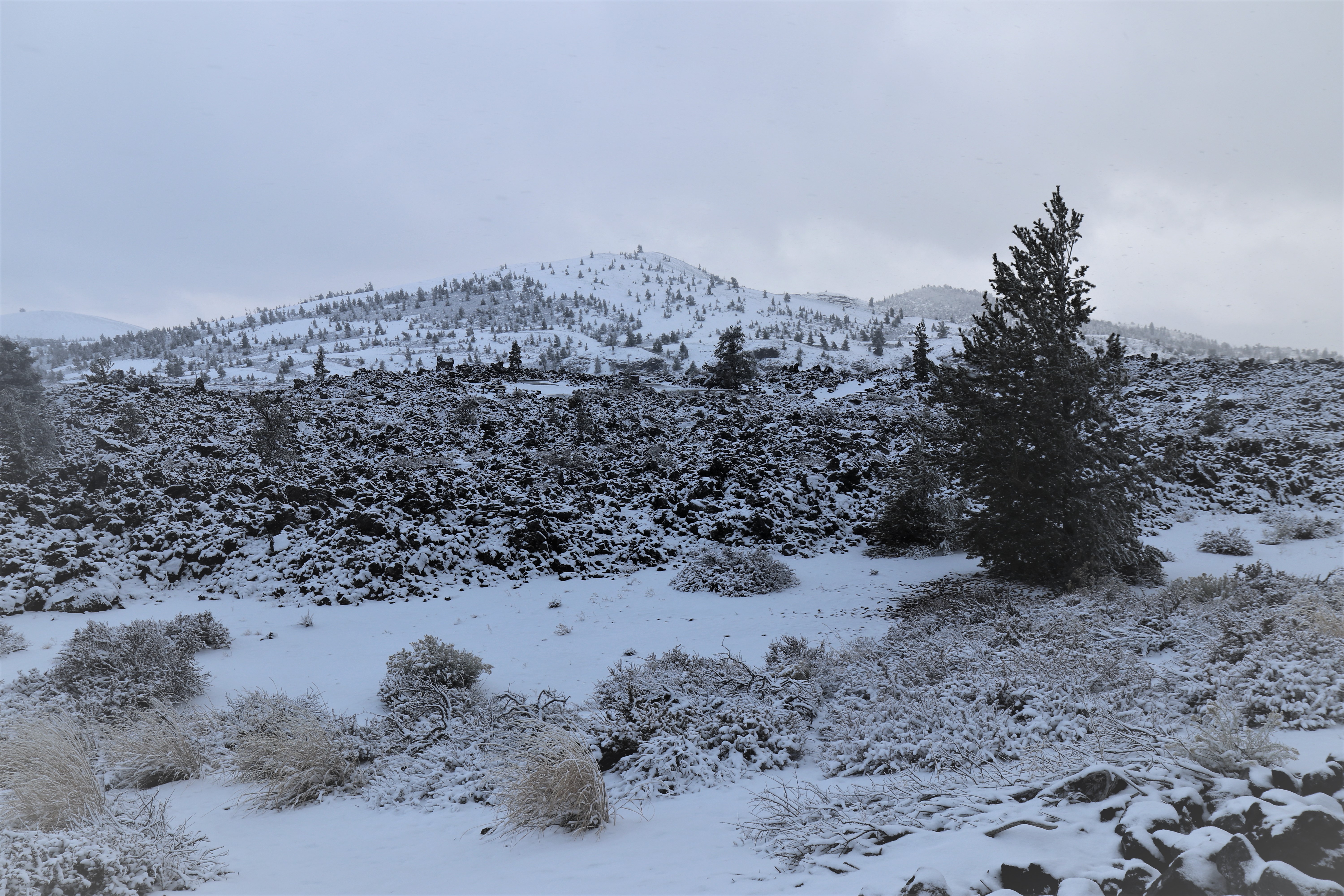 a mountain lava landscape covered in snow