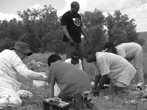 Figure 3: 5 members of the NAACP's Wichita Chapter youth group begin excavating a test pit on the midden feature, with assistance from a member of the Kansas Anthropological Association.