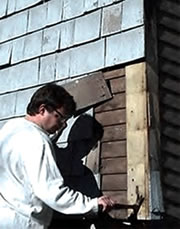 Deteriorated 20th century wood shingles are being removed to reveal the original, historic wood siding on this house in Portland, Maine, during its rehabilitation for continuing rental use. Photo: © John Leeke