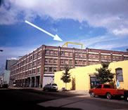 How to assess the impact of a proposed rooftop addition. Constructing a mock-up  (shown) or placing a brightly colored box or banner on the roof to show the height and the location of the proposed addition can help to determine the appropriateness of a rooftop addition on a historic building. Photographs taken of the mock-up from the street below and from several blocks away can suggest how visible an addition will be and how it will impact the character of the historic building and the historic district. Photo: NPS files