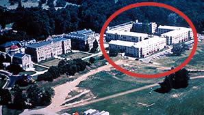 <two photo series> Incompatible New Construction. The setting of this historic college campus is a significant aspect of its design.  The three main historic structures (shown) are grouped around a rectangular court and overlook expansive lawns and playing fields. Several large new buildings (circled) were constructed as part of the rehabilitation that converted the historic campus into an extended-care retirement community. The form and siting of the new buildings, coupled with their size and massing, overwhelm the principal view of the site, and negatively impact its historic character. Photos: NPS files