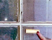 A new sample muntin, with its shallow, irregular profile (detail shown), looks very different from the simple, deeper profile of the glazing putty on the historic window. The new muntin would not be an acceptable replacement. Photo: NPS files