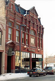 The transparency of glass is critical to the function of a shop window. The introduction of reflective glass (shown) is inconsistent with the historic character of this building. Photo: NPS files