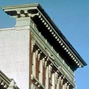 Removing the decorative cornice from the top of this 19th-century commercial building would detract from its overall historic character. Distinctive features should be retained and preserved. Photo: NPS files