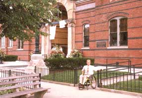 plantings and fencing minimize visibility of access ramp on facade