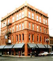 The new addition was designed to be flush with the existing facade in order to maximize the floor space. To further blend in with the historic district, the owner decided to use a cornice with brackets similar to the lost cornice--the spacing of the brackets was modified to include small modern windows.