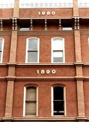 Dates were added to the facade to differentiate the historic construction from the new addition. Adding the dates (1890 and 1980) as a device did not, in and of itself, distinguish        old from new.
