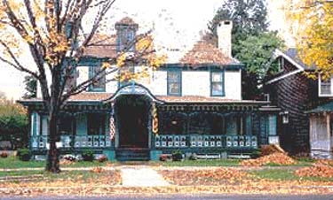 This large 2 1/2 story Queen Anne-style frame cottage was built around 1886 for a well-to-do client and is one of the most important residences in a small urban historic district. The exterior is characterized by a highly decorative porch. The interior of the house, while essentially intact, had undergone at least one major change in the 1950s when it was converted into five apartments. At that time, the main staircase was enclosed with drywall and a stained glass window on the landing removed. Photos: NPS files.