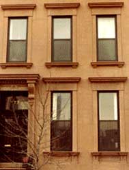The first coat of stucco applied to the stone substrate was tooled to     match, as much as possible, the original shape, design, and profile of        the stone trim and moldings. It was then covered over with a finish coat        of stucco, pigmented like brownstone, and finally, scored to resemble the original blocks of stone.