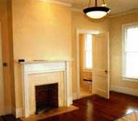 This shows the bedroom after the wallpaper was removed, with fresh coats of paint for the walls and trim.