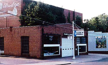 Built in 1932 the auto garage garage is a one-story brick building, three bays wide and four bays deep, with a flat tar and gravel roof. Only minor changes to the exterior have been made over time to accommodate its ongoing use. For example, a brick panel located above the garage door was removed in later years to allow larger vehicles to enter the service area. The historic sign pole can be seen in front of the garage. Photos: NPS files.