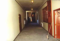 This shows new fire-rated doors that were installed in the preserved school corridors as part of the interior work.