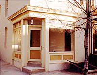 In preserving the existing storefront and corner entrance, the owner installed new plate glass in the existing openings and transoms and replaced the recently constructed brick infill below the plate glass windows with wooden panels. The cornice, often a significant element in storefront design, was also repaired and repainted.